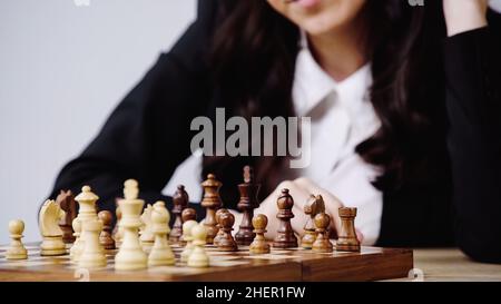 partial view of blurred businesswoman playing chess isolated on white,stock image Stock Photo