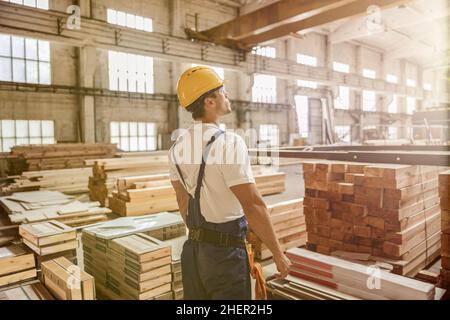 Male worker standing by construction materials in building Stock Photo