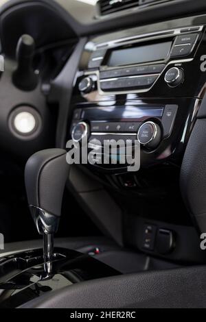Interior of new modern unknown car with automatic transmission in dealer showroom. Modern transportation. Stock Photo