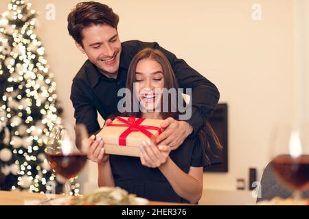 Young man giving gift box to his girlfriend Stock Photo