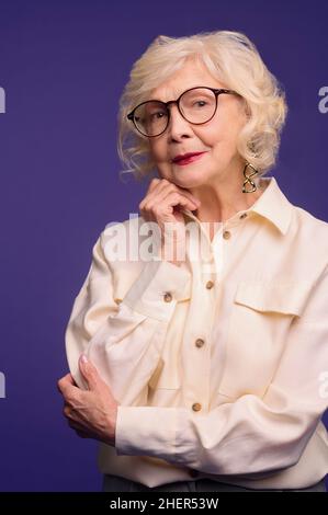 Slim and pretty blonde senior woman in stylish clothes Stock Photo