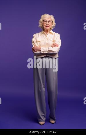 Slim and pretty blonde senior woman in stylish clothes Stock Photo