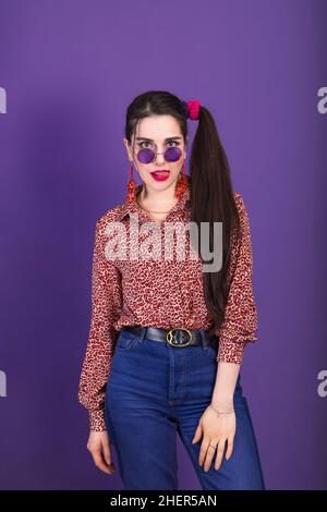 Style young brunette woman in 80s with round shape sunglasses and ponytail. Stock Photo