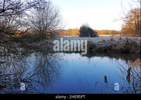 A seasonal view of the River Wensum on a frosty morning in winter in the countryside at Drayton, Norfolk, England, United Kingdom. Stock Photo