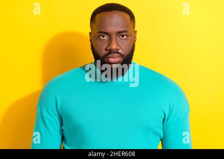 Portrait of calm focused concentrated person look camera wear sweater isolated on yellow color background Stock Photo