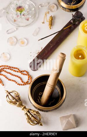 Pendulum, singing bowls and other healing tools for healing in Reiki stream on a white background Stock Photo