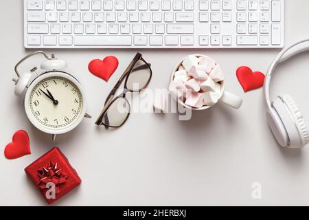 Desktop for valentine's day. Keyboard gift marshmallow on a gray table. Stock Photo