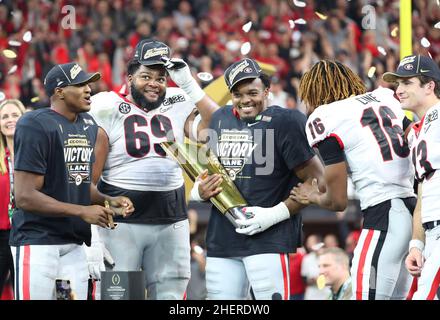 Georgia Bulldogs offensive lineman Jamaree Salyer (69) and defensive back Lewis Cine (16) celebrates during the trophy presentation of the 2022 CFP co Stock Photo