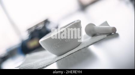 Frozen laboratory mortar with pestle after experiment with liquid nitrogen Stock Photo