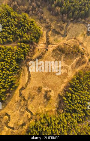 Aerial view of rural fields and small farm buildings surrounded by lush ...