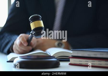 Male judge in courtroom hits with hammer Stock Photo