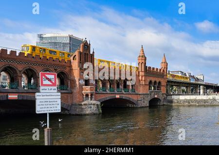 Yellow S-Bahn on Oberbaum bridge over the Spree river, Berlin, Germany Stock Photo