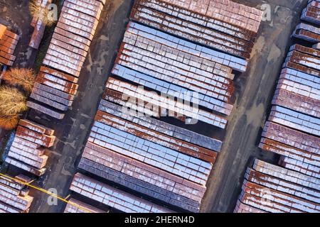 Stacks of bricks in a yard of brick factory. Piles of bricks stacked outdoor in a industrial warehouse aerial Stock Photo