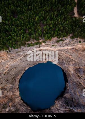 Half forest, half lake at the Red lake in April at Imotski, Dalmatia, Croatia Stock Photo