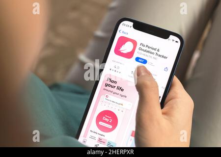 Kharkov, Ukraine - January 10, 2022: Flo Period and Ovulation tracker app icon closeup. Woman with application on Apple iPhone 12 Stock Photo