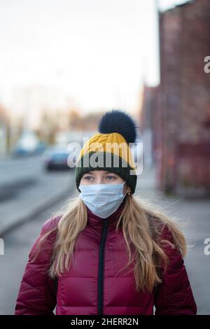 Woman wearing face mask to protect herself from virus. Coronavirus outbreak of flu epidemic concept Stock Photo