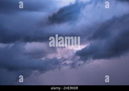 Light in the dark dramatic storm clouds background Stock Photo