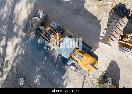 top view of heavy wheel loaded top loader digger on lime stone gravel Stock Photo