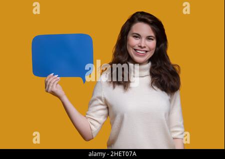 Smiling woman showing question sign before the camera Stock Photo