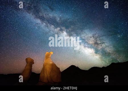 Milky Way with light on stone formations in the foreground at Goblin Valley State Park, Utah Stock Photo