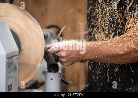 sawdust shavings of wood turnery while making a handcrafted bowl Stock Photo