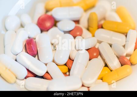 several colored medicine pills on white background Stock Photo
