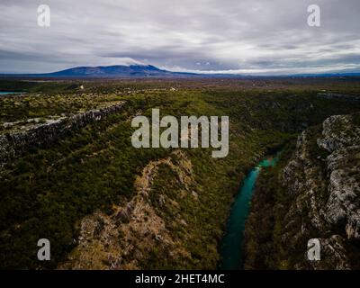 Aerial view of krka river in canyon in krka national park, Croatia. Mountains in the background Stock Photo