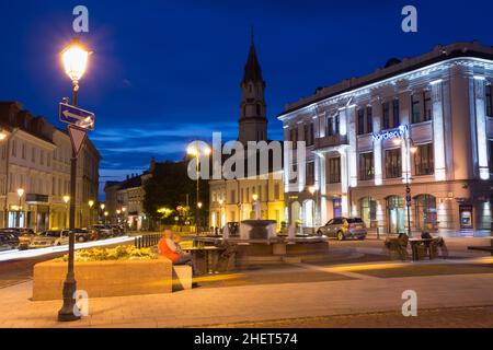Vilnius Lithuania. Fountain Between Illuminated Didzioji Street And Rotuses Square, Motion Blur Stock Photo