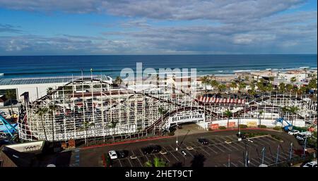 Aerial view Mission Beach, with wooden Giant Dipper roller coaster and amusement rides, historic Belmont Park at sunrise, San Diego, California, USA Stock Photo