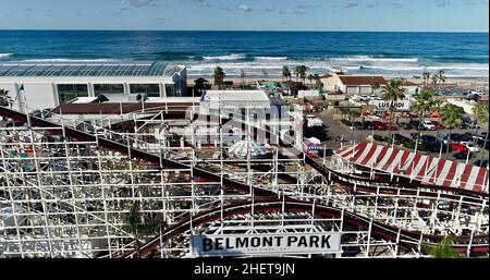 Aerial view Mission Beach, with wooden Giant Dipper roller coaster and amusement rides, historic Belmont Park at sunrise, San Diego, California, USA Stock Photo