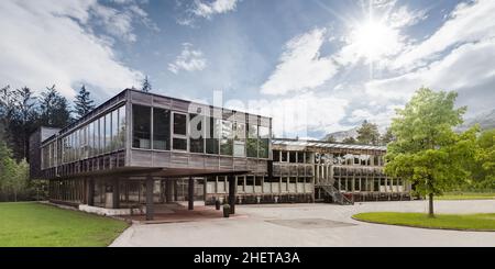 Wooden modern timber passive house with green tree Stock Photo