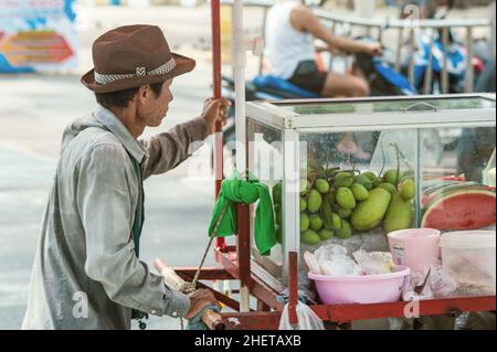 PHUKET, THAILAND - 11. MARCH 2018. An unidentified Asian vendor pushes mobile kitchen on the street. Day editorial shot Stock Photo