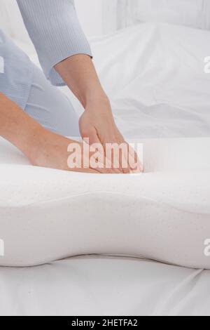 Orthopedic Pillow with a Memory Effect. Medical treatment pillow for sleep. Comfort Memory Pillow under the head with a recess under the shoulder Stock Photo