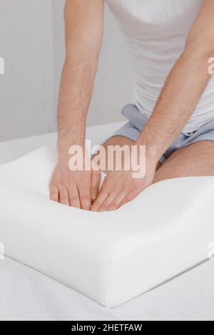 Orthopedic Pillow with a Memory Effect. Medical treatment pillow for sleep. Comfort Memory Pillow under the head with a recess under the shoulder Stock Photo