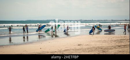 BALI, INDONESIA - 28. APRIL 2018. Beach full of surfers preparing to catch some waves. Day editorial shot Stock Photo