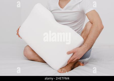 Orthopedic Pillow with a Memory Effect. Medical treatment pillow for sleep. Comfort Memory Pillow under the head with a recess under the shoulder Stock Photo