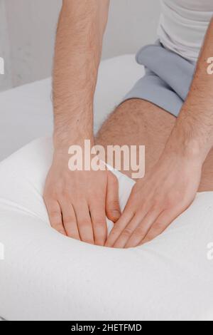 Orthopedic Pillow with a Memory Effect. Medical treatment pillow for sleep. Comfort Memory Pillow under the head with a recess under the shoulder Stock Photo