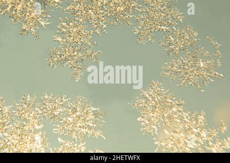 Festive, Christmas background. Lots of white snowflakes on a blue background. Close-up. Freezing. Winter. Macro photo of snowflakes. Stock Photo