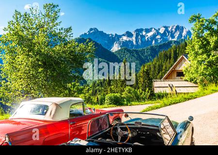 Vintage cars in front of slovenian Alps next to Logar valley, Slovenia Stock Photo