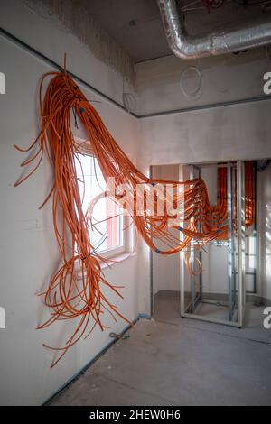 many orange network cables are laid in a new operating theater building Stock Photo