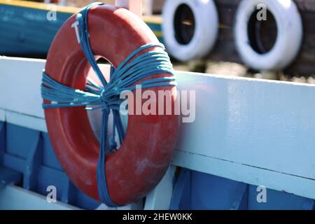 The buoy of a small sailing boat in the lagoon. A large lashing of ropes to secure it. Stock Photo