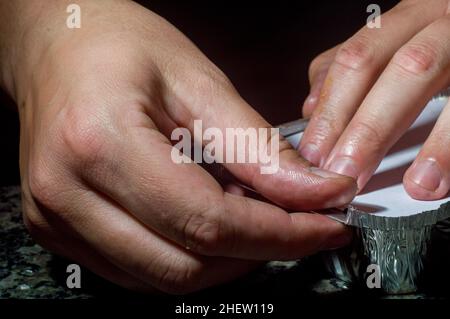 lasagna in an aluminum pan, spatula taking a piece of the pan, selective  focus Stock Photo - Alamy