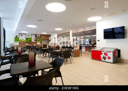 large self service restaurant with wood and rattan interior and long readout bar Stock Photo