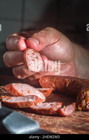 Sliced smoked calabrese sausage in a wooden table,copy space Stock Photo