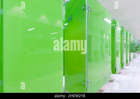 Perspective of green modern cabins at a swimming bath or pool Stock Photo