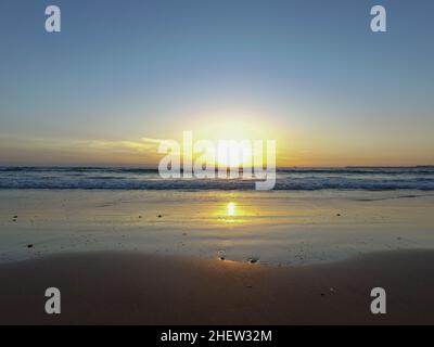 Beach photo taken in Agadir in Morocco in the summer time with the sun going down over the ocean. Stock Photo