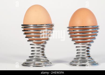 Soft-boiled eggs in coloured egg cups Stock Photo - Alamy