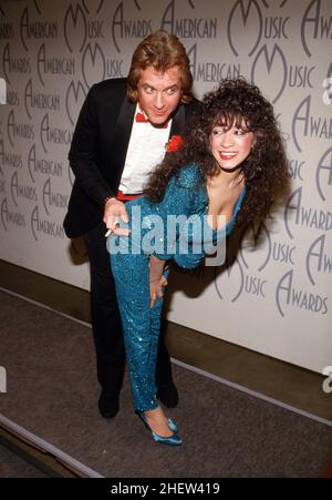 **FILE PHOTO** Ronnie Spector Has Passed Away. Eddie Money and Ronnie Spector at 14th Annual American Music Awards on January 26, 1987 at the Shrine Auditorium in Los Angeles, California Credit: Ralph Dominguez/MediaPunch Stock Photo