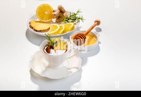 Ginger, lemon and herbs infusion tea served in a white porcelain cup. Copy space. Stock Photo