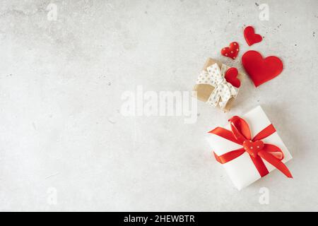 Background with gift and hearts with free space for text on concrete grey background. Valentines day concept. Mother's Day concept. Greetings card Stock Photo
